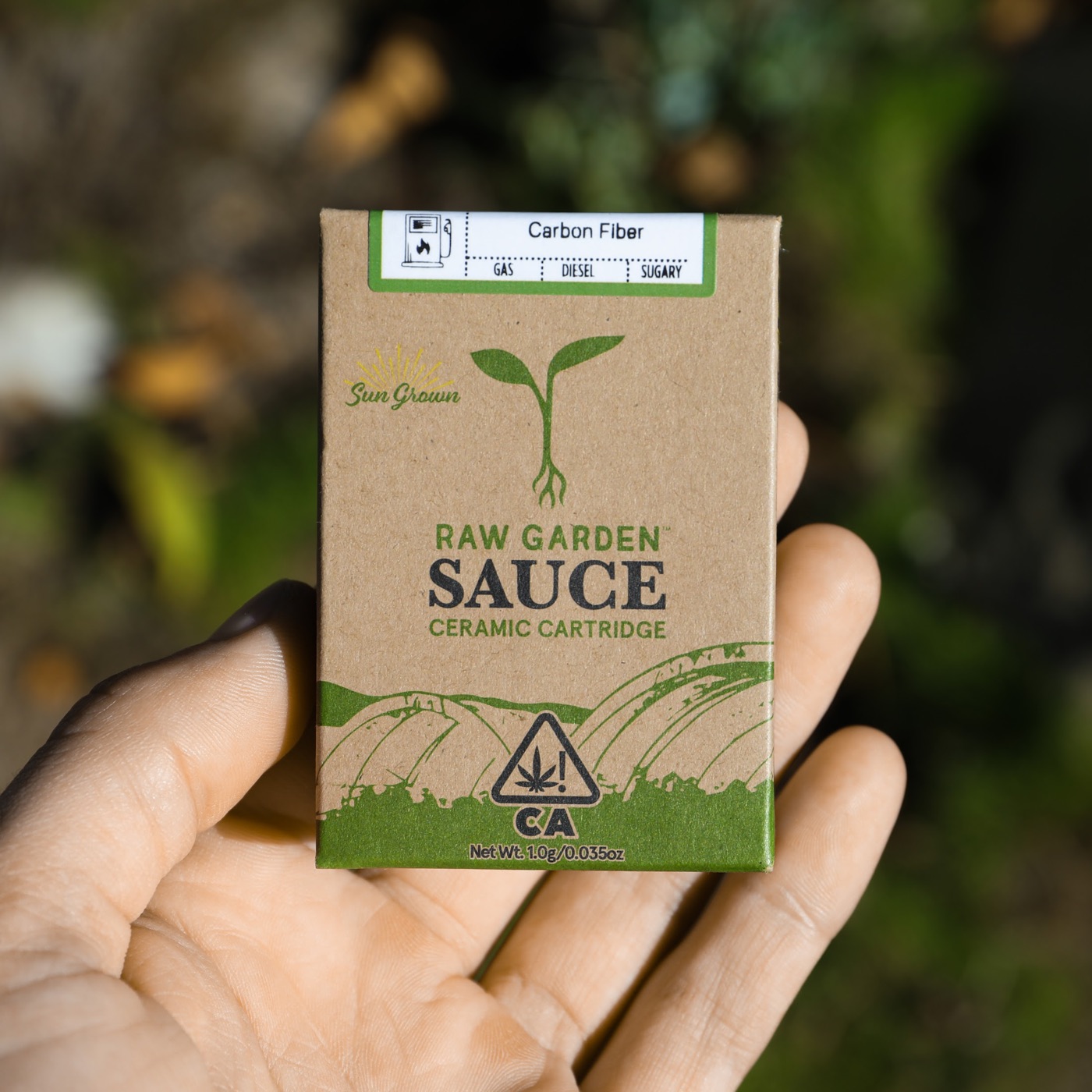 Raw Garden Sauce ceramic cartridge packaging, held in hand